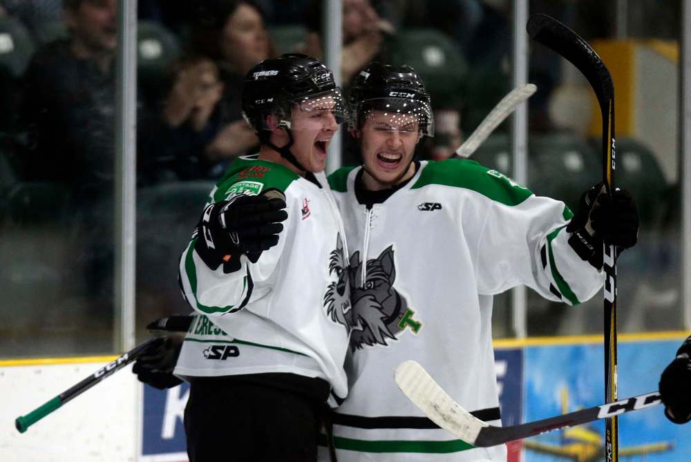 Joey Moffatt (left) celebrates with Caelan McPhee last season. The team's leading scorer was hoping to win the league championship in front of his friends and family. (Phil Hossack / Winnipeg Free Press files)