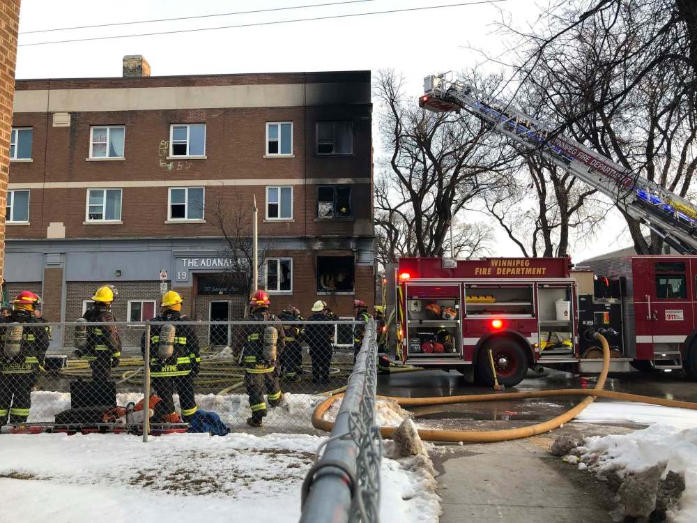 Firefighters were dispatched to the scene of a fire at Sargent Avenue and Beverley Street shortly before 6 a.m. Monday morning. Two people were sent to hospital, with one in critical condition, and other residents now need to find accommodations in the midst of the COVID-19 pandemic. (Maggie Macintosh / Winnipeg Free Press)