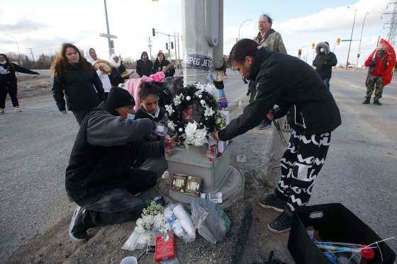 JOHN WOODS / WINNIPEG FREE PRESSWilliam Hudson and Christie Zebrasky, parents of 16-year-old Eishia Hudson, create a memorial for their daughter on Sunday. Hudson was shot to death by city police Wednesday night at Lagimodiere Boulevard and Fermor Avenue. She was in a stolen SUV with several other youths.