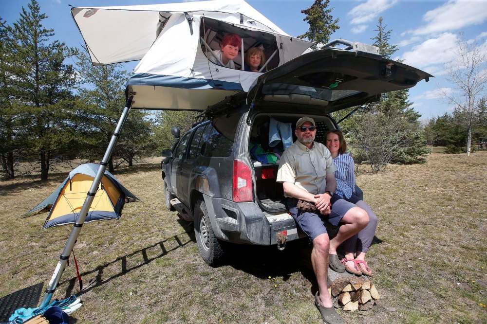 Kaitlan Knowles and Steve Pratt, with children Ginny, left, and Madeline, hang out in their tent as they camp this weekend in Birds Hill park. John Woods / Winnipeg Free Press