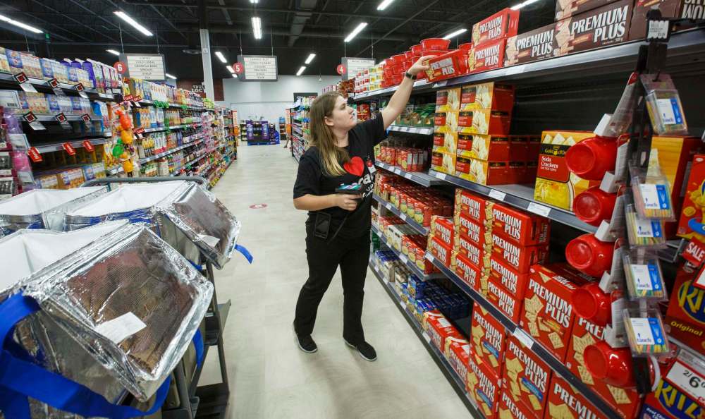 MIKE DEAL / WINNIPEG FREE PRESS
Lindsay Verwey, assistant supervisor of the e-commerce department at the Grant Park Red River Co-op, gathers a customer’s shopping order. The store launched its click-and-collect service Monday.