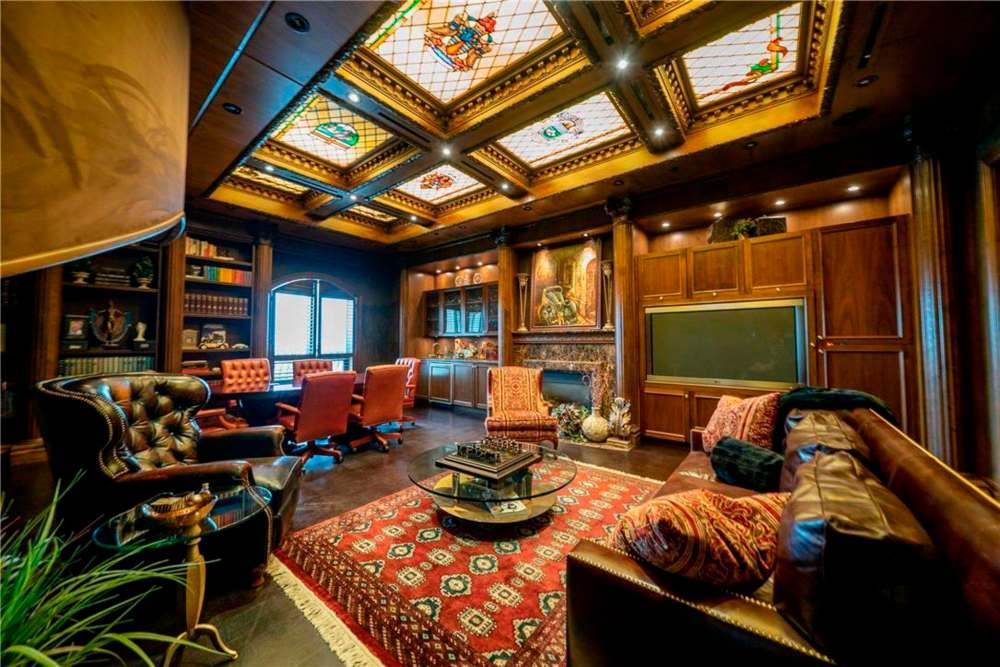 The suite is the very picture of opulence. In one of the main rooms, a candelabra-topped grand piano rests on a zebra rug alongside crystalware, all atop a wooden stage adorned with a music staff, all overlooking the Assiniboine River. (Realtor.com)