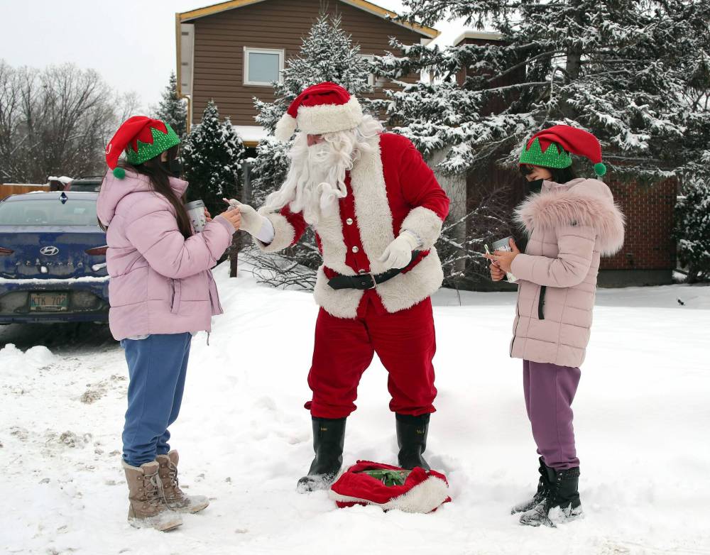 JASON HALSTEAD / WINNIPEG FREE PRESS Santa Claus (a.k.a. Dennis Radlinsky) arrives for a surprise visit to sisters Khloe, right, and Ava at the Charleswood home of their grandmother Theresa. Theresa set up the visit after the girls’ mother ended up in hospital in recent days. (Reporter: Malak Abas; family didn’t want last name used)