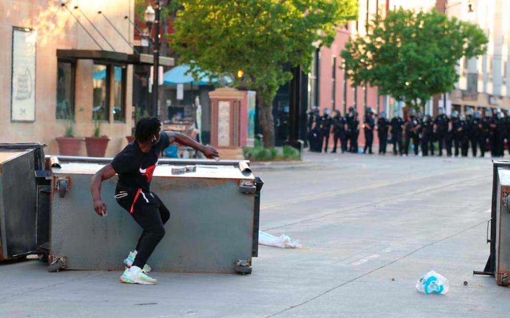 Some protesters threw rocks at police, despite being urged to remain non-violent by other protesters. C. S. Hagen / Fargo Forum
