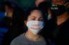 John Minchillo / The Associated Press
A woman outside a Minneapolis police station wears a protective mask that reads ‘I CAN’T BREATHE.’