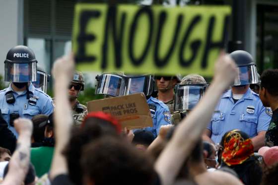 Matt Slocum / The Associated PressProtesters rally Monday as police officers and Pennsylvania National Guard soldiers look on in Philadelphia, over the death of Floyd.