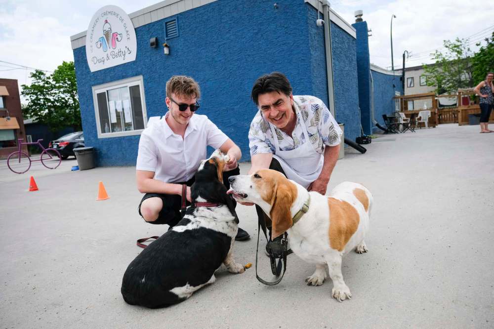 Fern Kirouac and his son Zac with their Bassett hounds, Dug and Betty.