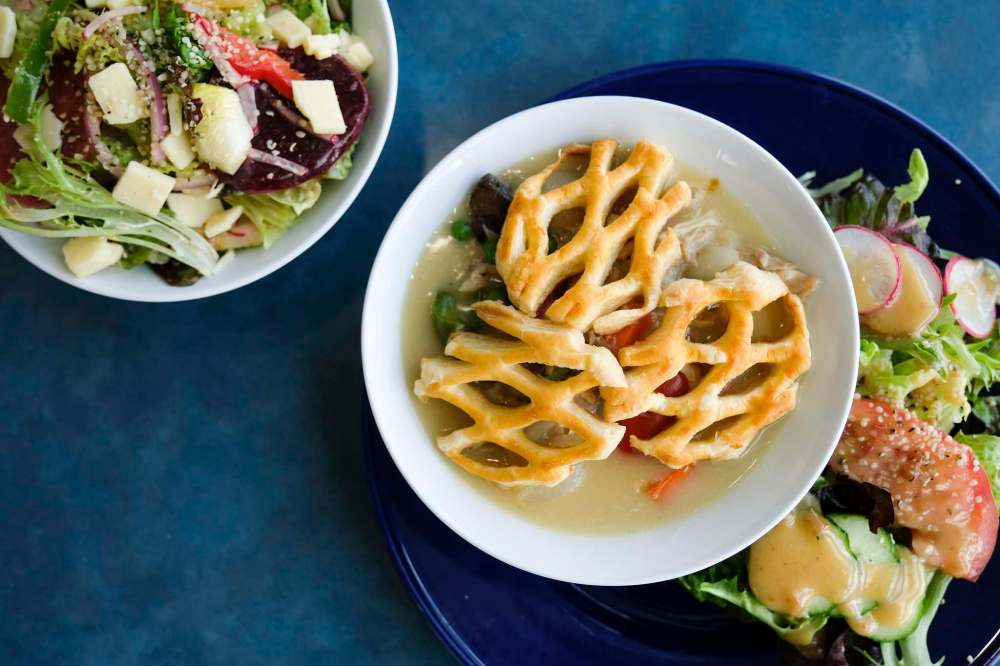 Beet salad (left) and chicken pot pie are popular menu options at Dug + Betty’s restaurant.