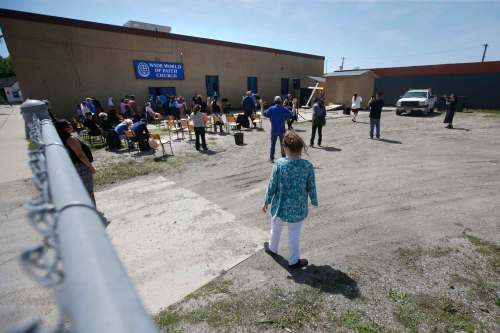 Church doesn't mean being inside. Teachings can also mean people meet regularly in houses or back yards, much like they did in the parking lot at the Wide World of Faith Church on May 31. (John Woods / Winnipeg Free Press files)