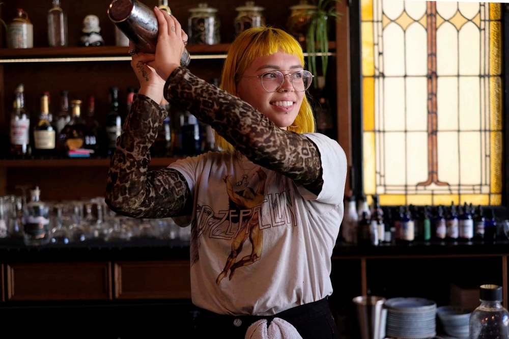 Bartender Justice Stevens-Illsley mixes a cocktail at Patent 5 Distillery, which reopened on Friday. (Shannon VanRaes / Winnipeg Free Press)