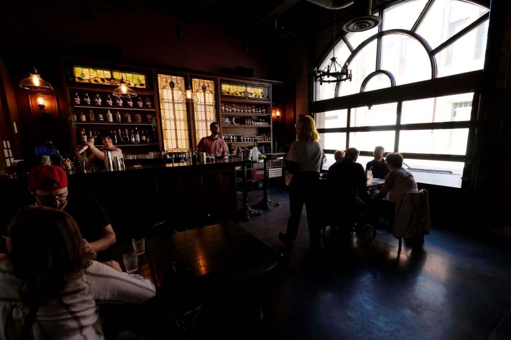 Tables are widely spaced at Patent 5 Distillery. At only half-capacity, the cocktail room quickly fills up. (Shannon VanRaes / Winnipeg Free Press)