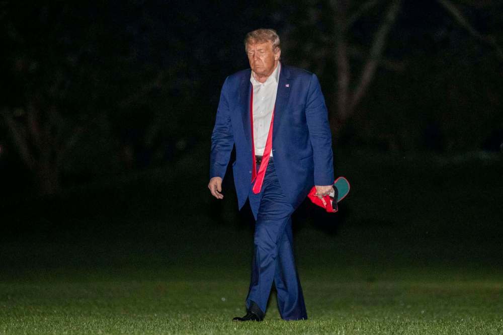 Patrick Semansky / The Associated Press
U.S. President Donald Trump returns to the White House early Sunday.