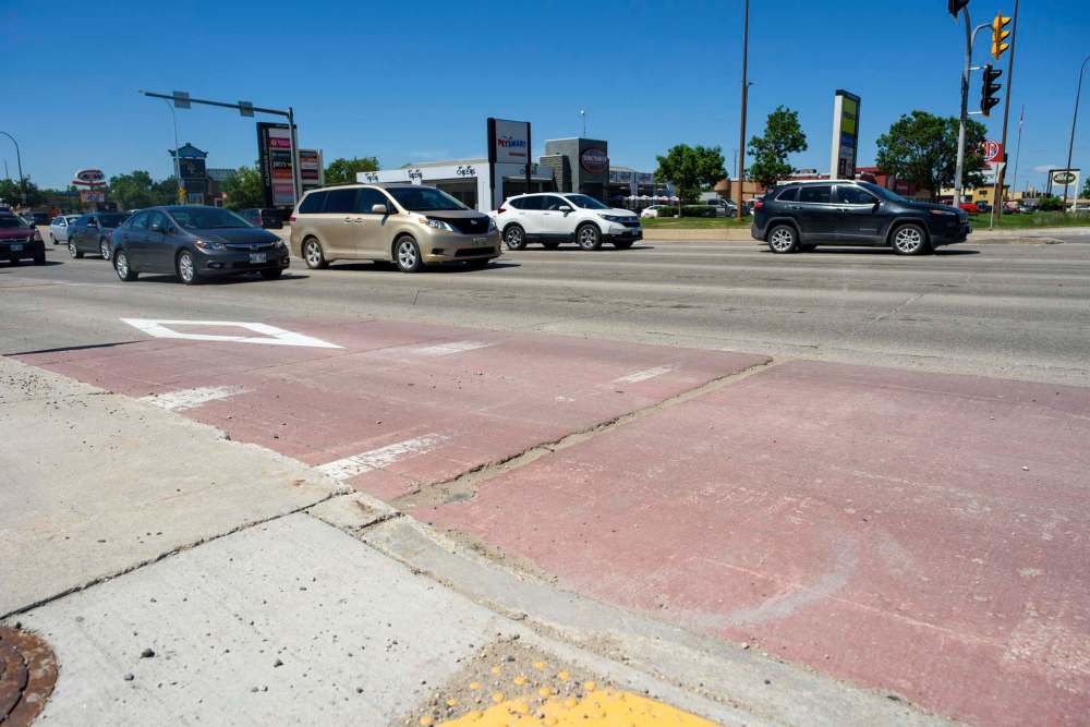 JESSE BOILY / WINNIPEG FREE PRESS
Snow-clearing, road sands and other Manitoba weather realities strip away lane-marking paint, leaving just a few flecks of colour or blank pavement behind.