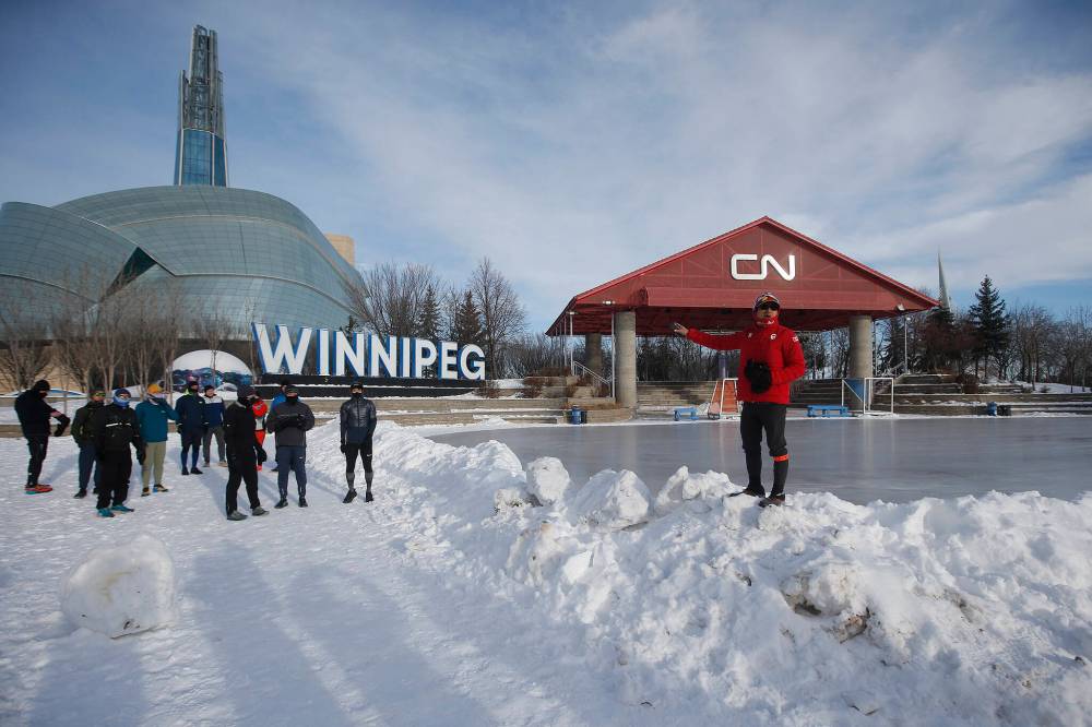 Junel Malapad, right, readies for his 200-km charity run in Winnipeg on Sunday. Malapad is raising money for Siloam Mission. (JOHN WOODS / WINNIPEG FREE PRESS)