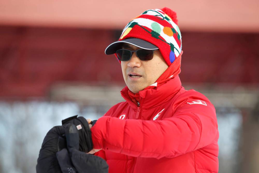 Junel Malapad sets his stopwatch prior to his charity run at The Forks in Winnipeg on Sunday. (JOHN WOODS / WINNIPEG FREE PRESS)