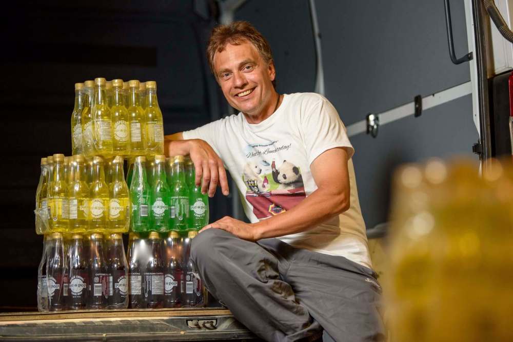 Michael Nykorak, the plant manager at Canadian Gold Beverages, with a stack of Pic-a-Pop. Canadian Gold uses the original formulas to produce classic Pic-a-Pop flavours. (Jesse Boily / Winnipeg Free Press)