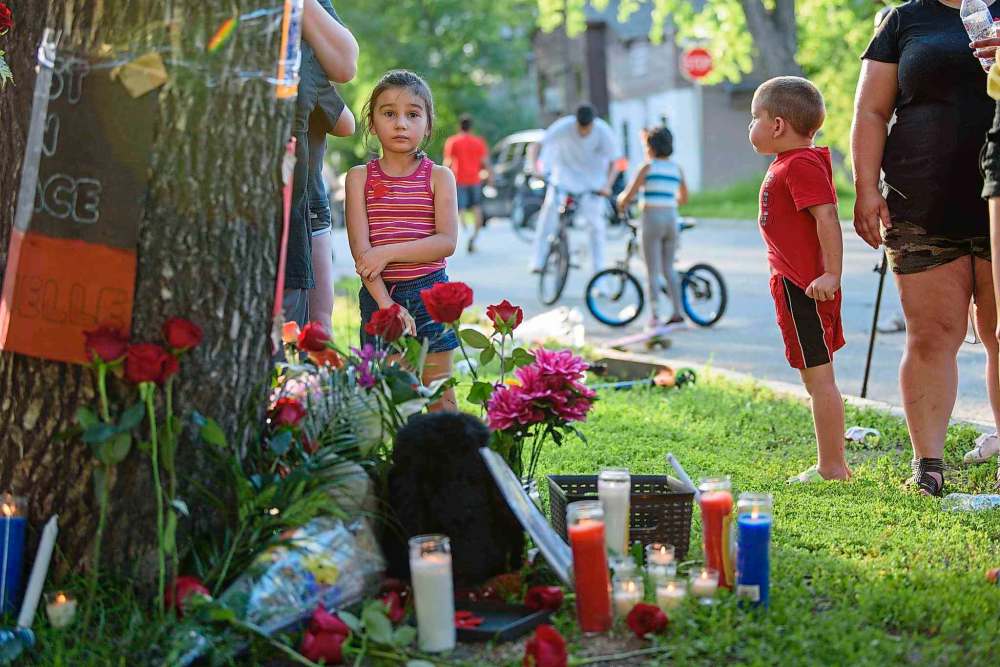 A vigil for 27-year-old Danielle Cote drew more than 40 supporters July 3 to the 400 block of Flora Avenue, where the mother of four was shot and killed two days earlier. The Winnipeg Police Service announced Saturday a second teen suspect has been charged with first-degree murder in Cote's death. Two boys, 14 and 15 years old, have now been charged in the homicide as well as in a series of other shootings that happened July 1 and 2 in Winnipeg.
(Jesse Boily/Winnipeg Free Press)
