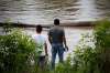 A man and boy look out over the water as the Winnipeg police underwater search and rescue units search the Red River for nine-year-old Darius Bezecki. John Woods / Winnipeg Free Press