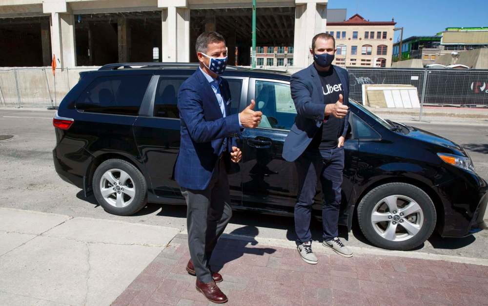 Winnipeg Mayor Brian Bowman arrives at City Hall in an Uber driven by Michael van Hemmen, head of city operations for Uber in Canada. (Mike Deal / Winnipeg Free Press)