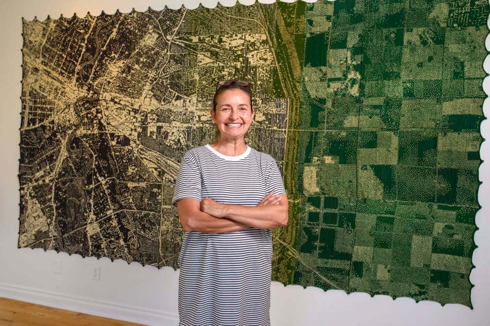 JESSE BOILY / WINNIPEG FREE PRESS
Astrid Alexandra Keim, director of La Maison des artistes visuals francophone, with one of Mylène Michaud’s site-specific works inspired by a view of Winnipeg from above.