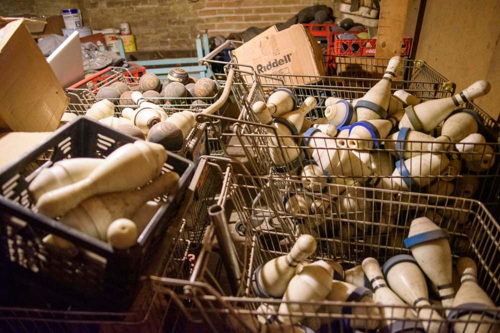 Carts of bowling pins and balls and old bowling shoes from the past sit in the basement at Roxy Lanes. (Jesse Boily / Winnipeg Free Press)