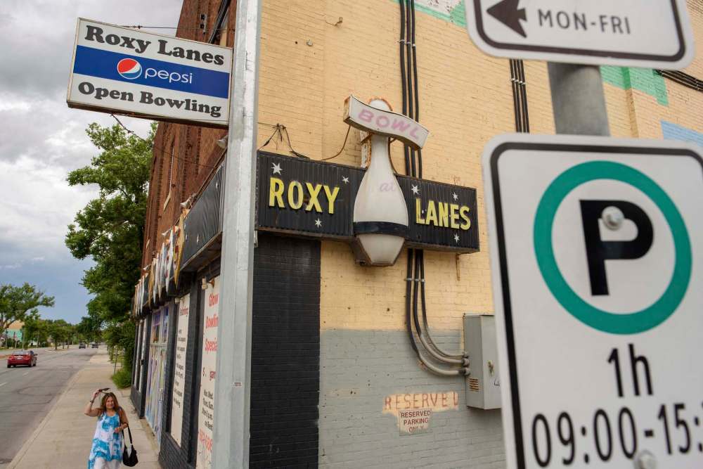 Melissa Gauthier leaves the Roxy Lanes bowling alley after a recent shift. Business has been slow despite regulations allowing bowling alleys to open, though Melissa says the phone is starting to ring again. (Jesse Boily / Winnipeg Free Press)