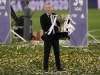 Real Madrid's head coach Zinedine Zidane, holds the trophy after winning the Spanish La Liga 2019-2020 following a soccer match between Real Madrid and Villareal in Madrid, Spain, Thursday. (AP Photo/Bernat Armangue)