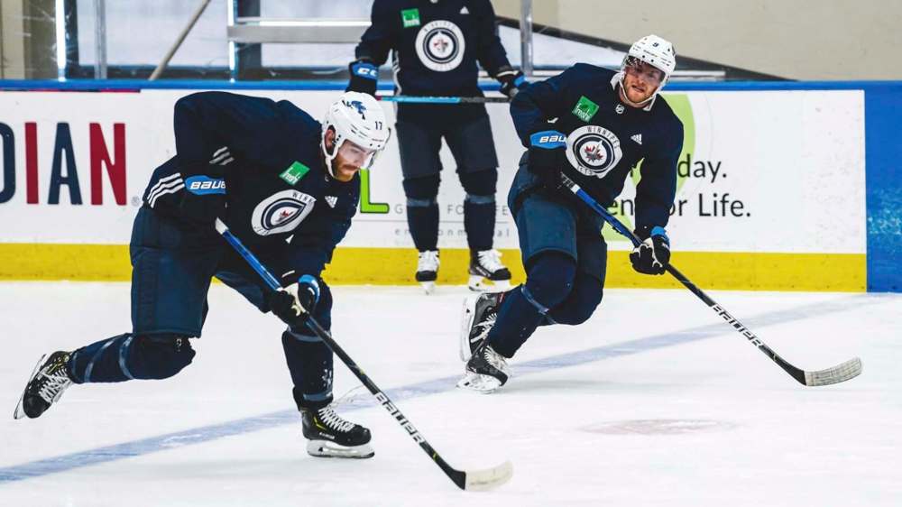 Adam Lowry (left) and Andrew Copp during practice Tuesday in Edmonton. (Tyler Esquivel / Winnipeg Jets)