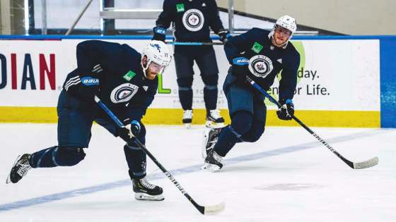 Adam Lowry (left) and Andrew Copp during practice Tuesday in Edmonton. (Tyler Esquivel / Winnipeg Jets)