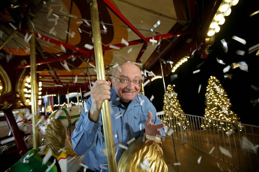Ron Paley has some fun trying out the merry-go-round at the convention centre prior to his band's 2017 New Year's Eve party. (Ruth Bonneville / Winnipeg Free Press files)
