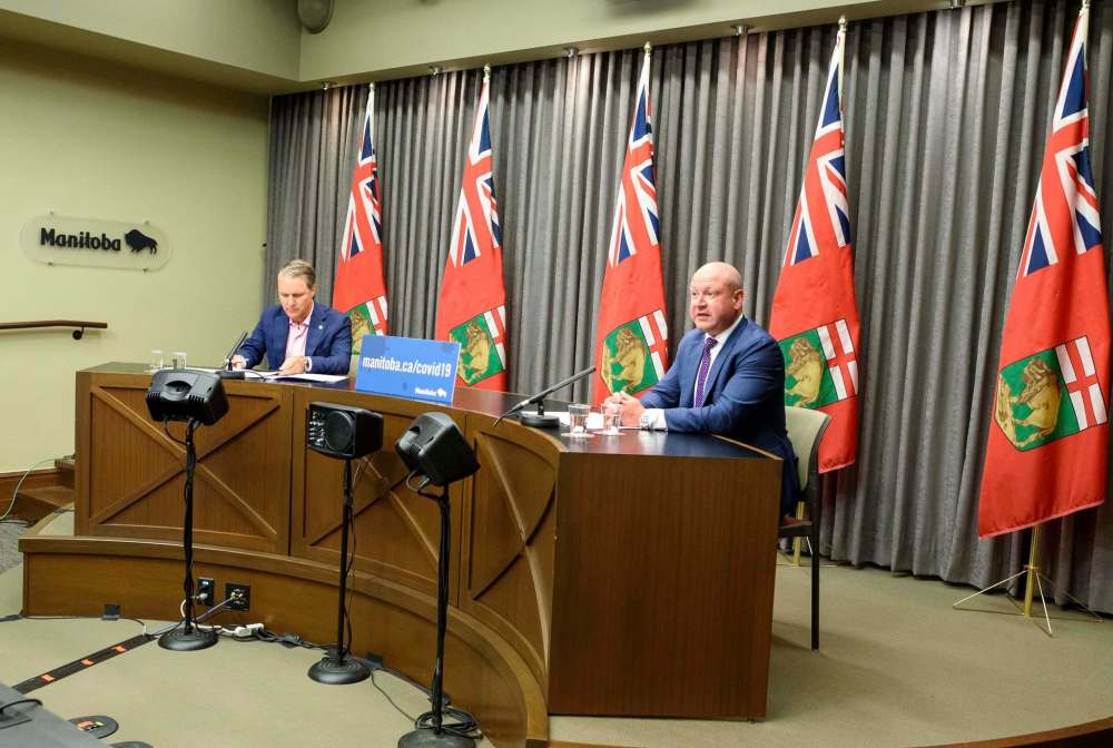 JESSE BOILY / WINNIPEG FREE PRESSDr. Brent Roussin, right, chief provincial public health officer Health, and Seniors and Active Living Minister Cameron Friesen give an update on the COVID-19 response in the province at the Legislature building on Monday. Monday, Aug. 10, 2020.Reporter: Larry