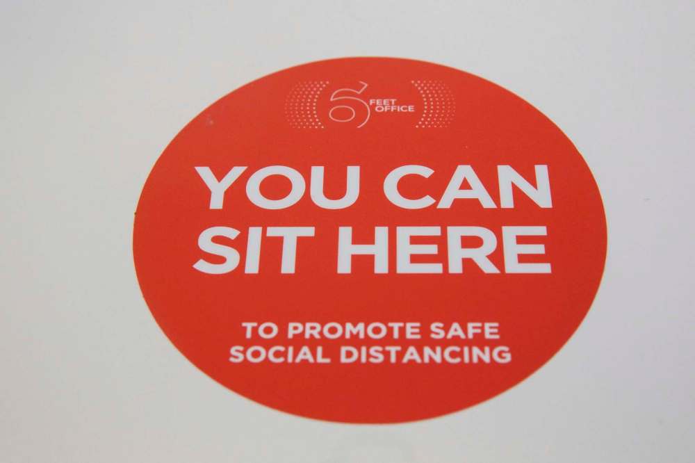 A sticker positioned on a conference room table at Cushman & Wakefield Stevenson's at 55 Donald Street. (Mike Deal / Winnipeg Free Press)