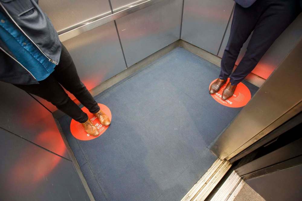 Decals show the two occupants allowed inside the elevator where to stand. (Mike Deal / Winnipeg Free Press)