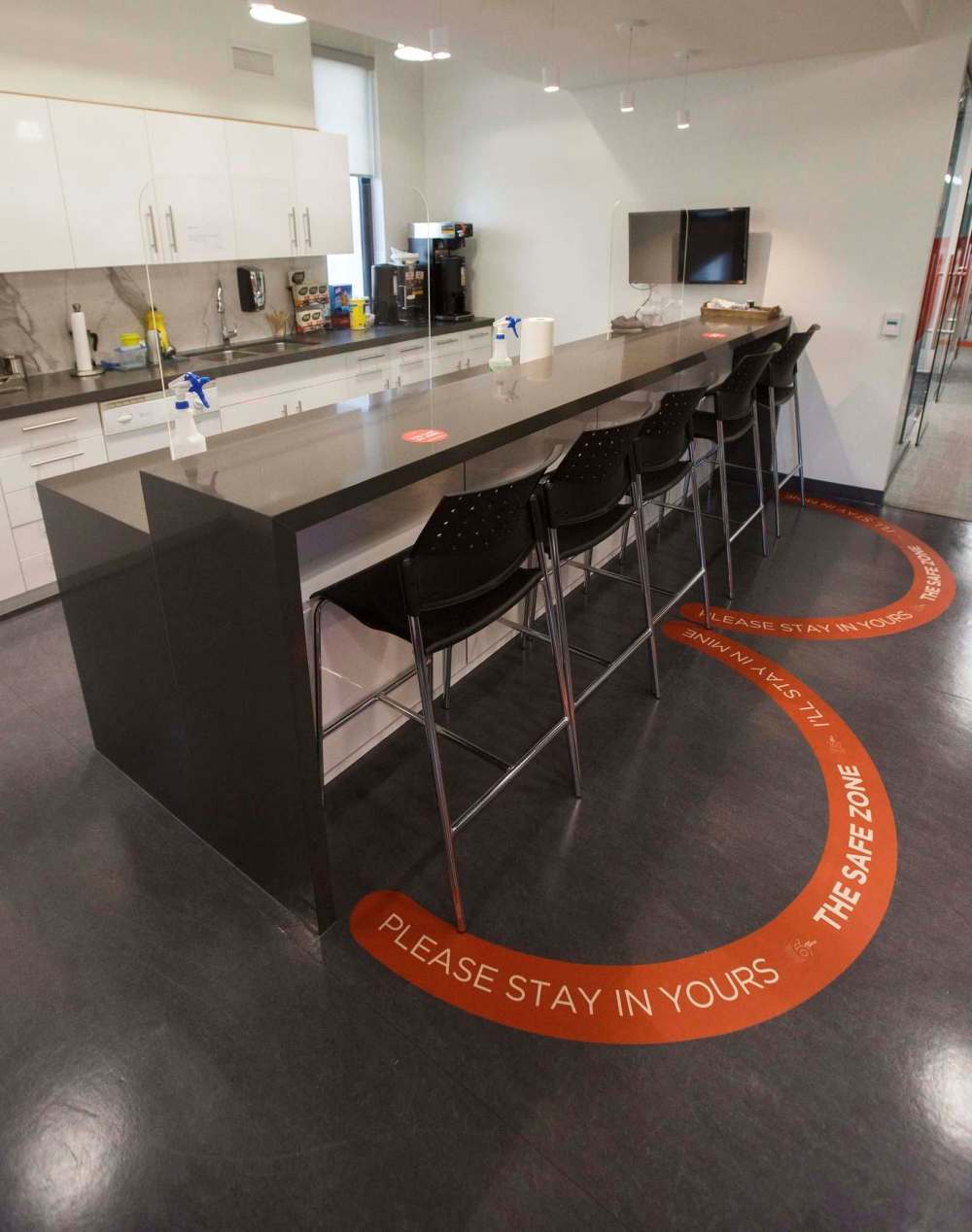 Stickers with directions help to remind visitors and staff to keep social distancing from being forgotten. (Mike Deal / Winnipeg Free Press)