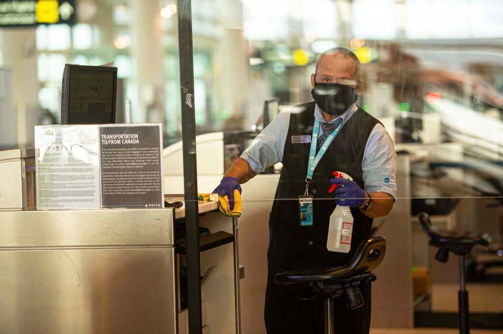 A worker sanitizes a terminal at the Richardson International Airport. (Mike Sudoma / Winnipeg Free Press files)