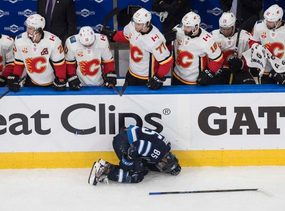 Winnipeg Jets' Mathieu Perreault is injured in a game against the Calgary Flames during the qualifying round in Edmonton in August. The Jets, once a physically imposing team with the likes of Dustin Byfuglien and Tyler Myers patrolling the blueline, are not so intimidating anymore. THE CANADIAN PRESS/Jason Franson