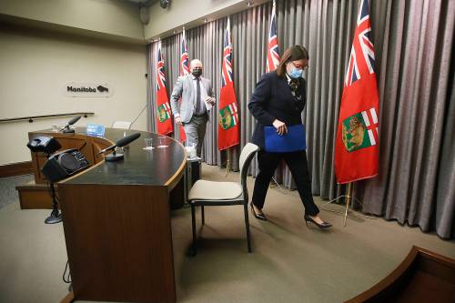 JOHN WOODS / WINNIPEG FREE PRESS FILES
Dr. Brent Roussin (left), Manitoba’s chief public health officer, and premier Heather Stefanson leave the province’s Dec. 27, 2021 COVID-19 update at the Manitoba legislature.