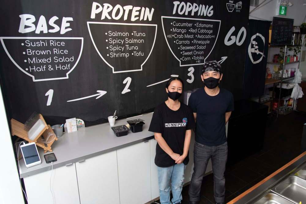 JESSE BOILY / WINNIPEG FREE PRESS
Andy Zhehong Wen, owner of Poké Mono, and his wife Lily Zhao at the downtown restaurant.
