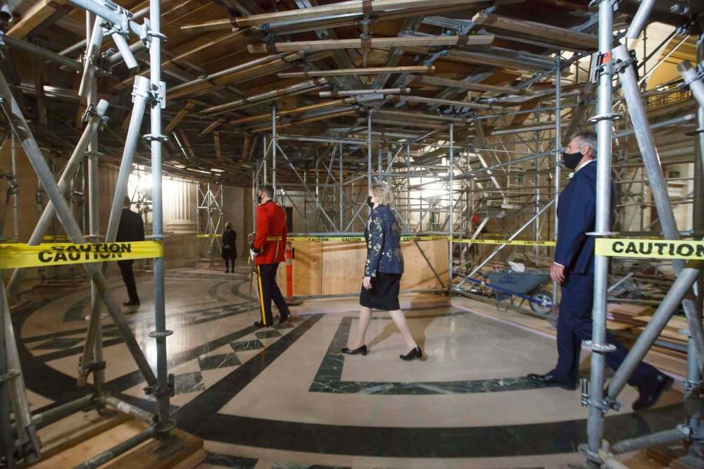 MIKE DEAL / WINNIPEG FREE PRESSLieutenant Governor of Manitoba, Janice Filmon, Premier Brian Pallister and other officials pass beneath scaffolding in the rotunda as they head towards the Assembly chambers for the Speech from the throne Wednesday afternoon.201007 - Wednesday, October 07, 2020.