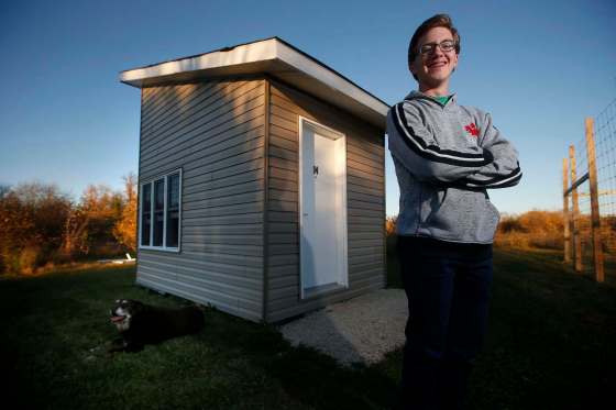 JOHN WOODS / WINNIPEG FREE PRESSNoah Jonker, 15, with his dog Bentley outside the 96 sq. ft. house he built in his family’s backyard in the RM of Springfield .