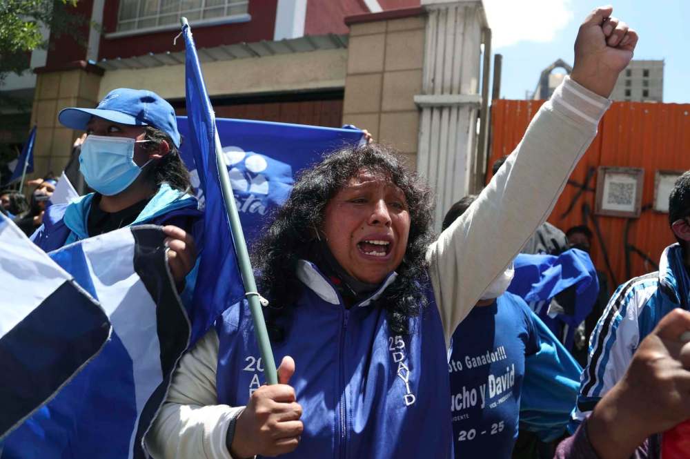 Martin Mejia / The Associated Press
Supporters of presidential candidate Luis Arce shout slogans outside his headquarters one day after elections in La Paz, Bolivia, Monday.