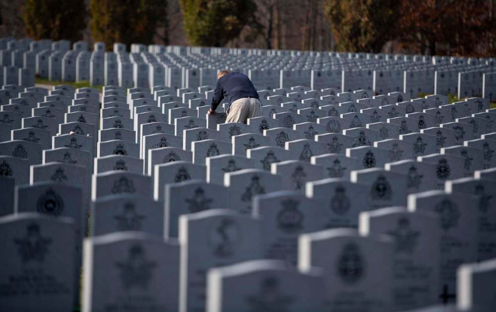 Justin Tang / THE CANADIAN PRESS
George Williston, who served in the Royal Canadian Army Service Corps, pays his respects at the National Military Cemetery in Ottawa on Saturday.