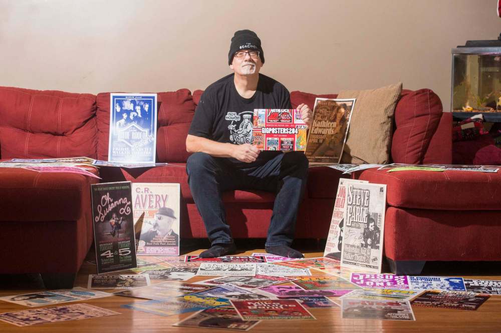 Mike Sudoma / Winnipeg Free Press
Stu Reid aka “Stu Art” holds up his newly released “Gig Posters” calendar, while being surrounded by “just a few” of the posters he’s designed over the years.