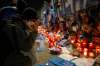 Alessandra Tarantino / The Associated Press
Fans look at memorabilia Thursday outside the San Paolo stadium commemorating soccer legend Diego Maradona, in Naples.