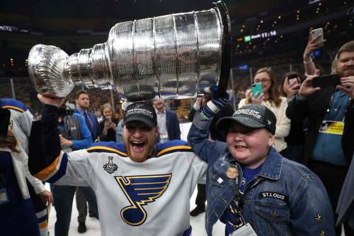 Patrick Smith / Getty Images
In this June 2019 photo, Colton Parayko (left) of the St. Louis Blues and Laila Anderson celebrate with the Stanley Cup after the Blues defeated the Boston Bruins. Anderson&rsquo;s story is one of many feel-good moments in James Duthie&rsquo;s new book.