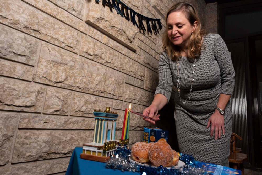 JESSE BOILY / WINNIPEG FREE PRESS
Rena Secter Elbaze lights her menorah outside her home on Tuesday. Many of the items that people use to celebrate Hanukkah have been unavailable to purchase as the holiday approaches.