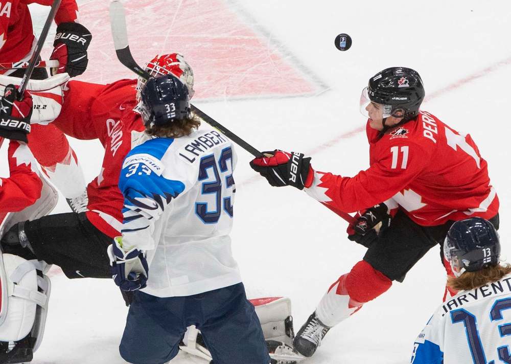 JASON FRANSON / THE CANADIAN PRESS
Canada's Cole Perfetti (11) battles for a rebound during third period against Finland in IIHF World Junior Hockey Championship action in Edmonton, Thursday, Dec. 31, 2020.