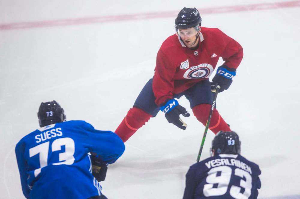 MIKAELA MACKENZIE / WINNIPEG FREE PRESS
Neal Pionk keeps his eye on the competition at Jets training camp at BellMTS Iceplex Tuesday.