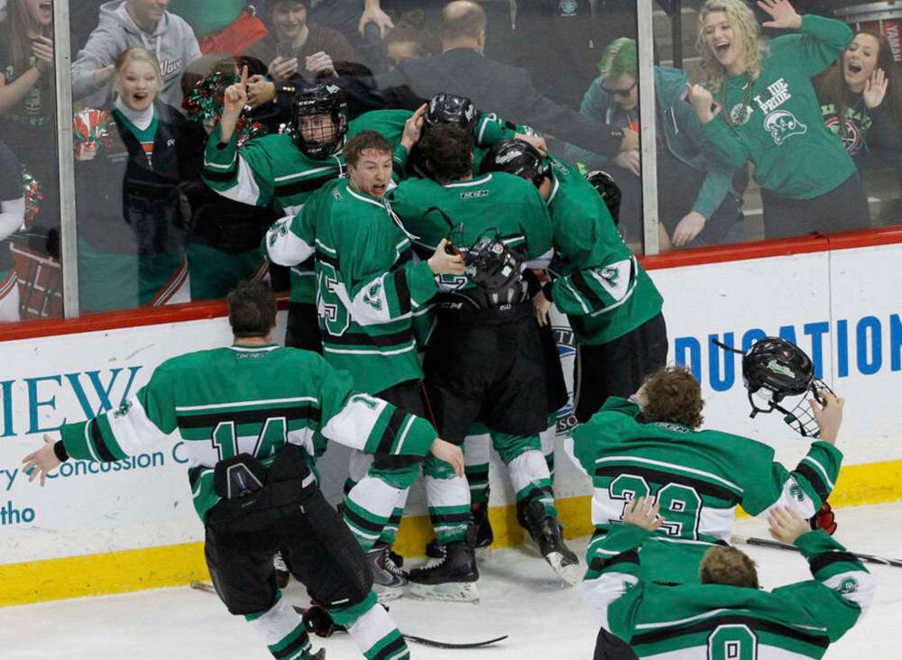 East Grand Forks players and fans celebrate after East Grand Forks defeated Hermantown in the boys' Class A state hockey tournament championship game in St. Paul, Minn., in 2015. (AP Photo/Ann Heisenfelt)