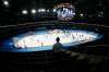 An official looks over the rink as the Winnipeg Jets and Calgary Flames warm up in an empty arena prior to their opening game of NHL action in Winnipeg, Thursday. THE CANADIAN PRESS/John Woods